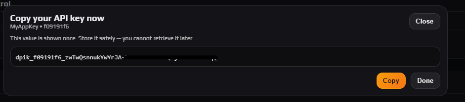 Copy your API key now dialog showing the one-time key value with Copy and Done buttons