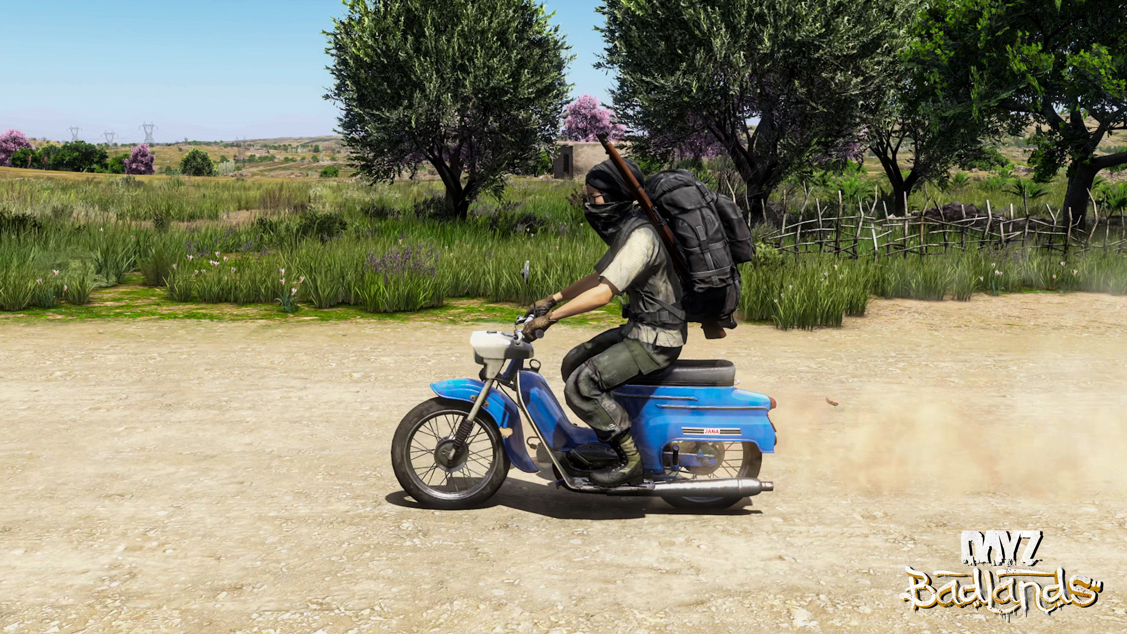 A vehicle throwing up a trail of dust across arid terrain in Nasdara